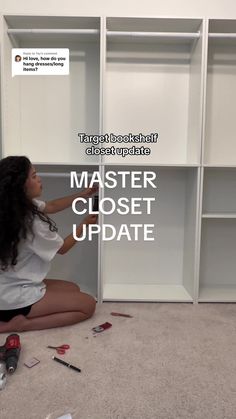 a woman sitting on the floor in front of a bookcase with torn paper all over it