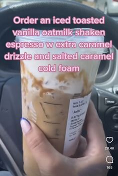 a person holding up a drink in their hand with the words order an iced toasted vanilla oatmilk shaker espresso v extra caramel drizze and salted caramel cold foam