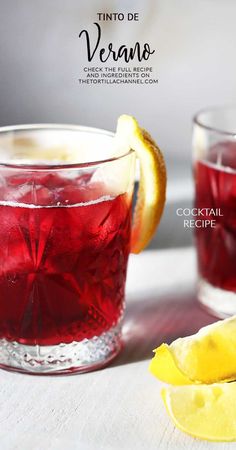 two glasses filled with red drinks next to lemon wedges and a slice of lemon