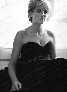 a black and white photo of a woman in a strapless dress