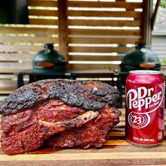 a can of dr pepper next to some ribs