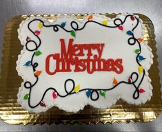 a merry christmas cake with lights on it