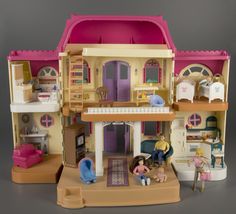 there is a doll house and toys on the floor