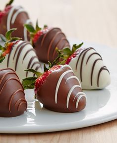 chocolate covered strawberries sit on a plate with the words did or berry written below them