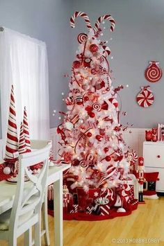 a red and white christmas tree decorated with candy canes, lollipops and candies