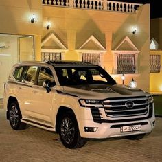 a white suv parked in front of a building