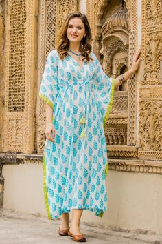 Spend your vacations in a stylish leafy print by Aftab in India. This cotton caftan offers the height of comfort with a flattering waistline. The white cotton garment is adorned with turquoise leaves and trimmed in vibrant green. Charming beaded tassels add a touch of texture. Kaftan Kurti, Kaftan Set, Kaftan Design, Kaftan Tops, Kaftan Designs, Cotton Caftan, Cotton Long Dress, Long Kaftan, Cotton Kaftan