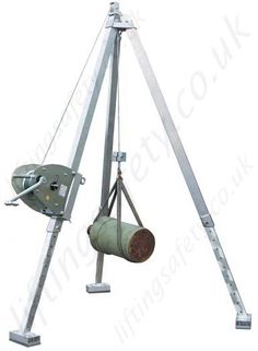 a large metal object hanging from the side of a white wall with an antenna attached to it