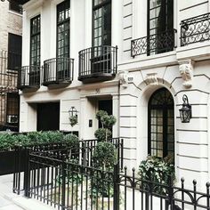 an apartment building with balconies and wrought iron railings