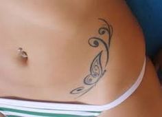 an image of a woman's stomach with tattoos on it