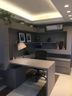 an office with a desk, chair and air conditioner