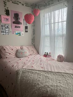 a bedroom with pink and white decorations on the walls