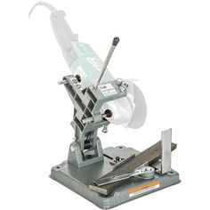 a machine that is sitting on top of a metal stand with tools in front of it