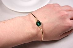 Rose Gold Emerald Swarovski Crystal Bracelet Handmade by Jessica Luu Jewelry ~ Faceted ~ Versatile ~ Elegant ~ With every wave of your hand, there will be a sparkle of emerald green at your wrist as this bangle moves around. Emerald is the birthstone for May making this a thoughtful birthday gift for someone special. MATCHING ITEMS https://www.etsy.com/shop/JessicaLuuJewelry?search_query=emerald MATERIALS: ~ 10mm emerald Swarovski crystal ~ 14K gold filled wire HOW IT'S MADE: A large Swarovski c