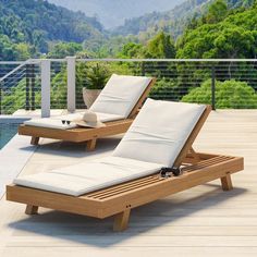 two lounge chairs sitting on top of a wooden deck