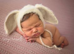 a newborn baby wearing a bunny ears hat