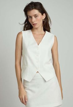 Sizes : xs - l  color: white  button up vest  56% linen 44% cotton  dry clean  by the nkc store    product measurements:  bust:  86.36cm / 34in  length: 54.61cm / 21.50in    model is 177cm / 5'10" wearing size o/s Woman Vest, White Button Up, Caged Sandals, Black Tank Dress, Black Aviators, Neon Purple, Outerwear Vest, Boyfriend Tee, Engineered Garments