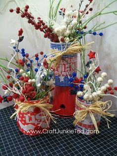 two red white and blue vases filled with flowers