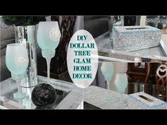 three glass vases sitting on top of a table next to a mirror with the words diy dollar tree glam home decor