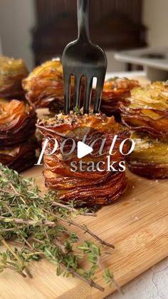 a wooden cutting board topped with lots of food and a fork sticking out of it