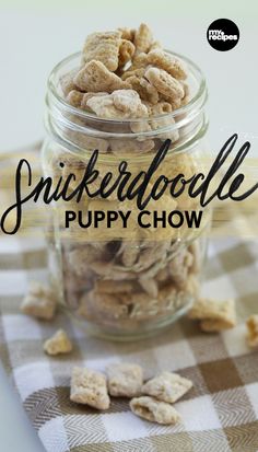 a glass jar filled with dog food sitting on top of a checkered table cloth