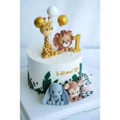 a birthday cake with animals and balloons on it's top tier is the number one