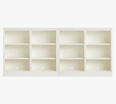 an empty white bookcase with three shelves on one side and two open ones on the other