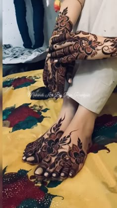 a woman with henna on her hands and feet