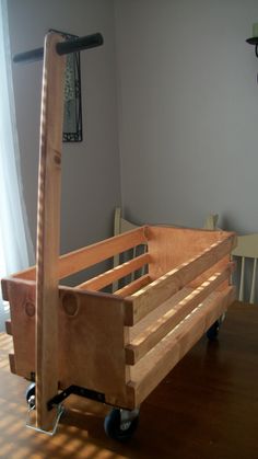 a wooden bed frame sitting on top of a hard wood floor next to a window