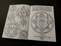 an open book with various symbols on it