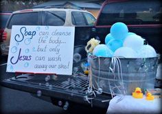 a sign that is sitting on the back of a truck with soap and toys in it