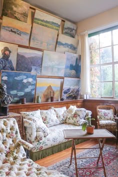 an instagram photo of a living room with couches and paintings on the wall