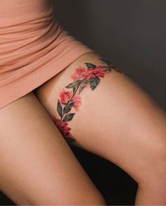 a woman's thigh with flowers painted on it