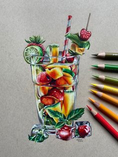 colored pencils and crayons are next to a drawing of a glass of fruit