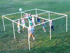 some kids are playing with a ball in the grass and there is an advertisement about it