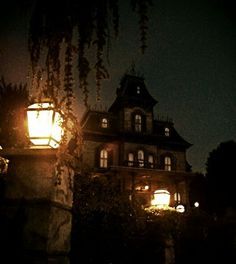 an old fashioned house lit up at night