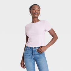 This Shrunken Short-Sleeve T-Shirt from Universal Thread™ makes a go-to pick for warm-weather wear. Fashioned in a standard silhouette with a mid length, it features a basic crewneck for timeless style. The 100% cotton fabric offers cool comfort, and you can coordinate it with different shorts or pants and pair it with your favorite layering pieces to create a range of outfits. Universal Thread™: Found exclusively at Target. Basic Crewneck, High Neck Tank Top, Weather Wear, Of Outfits, Slim Fit Shorts, Workout Tank Tops, Universal Thread, Layering Pieces, Timeless Style