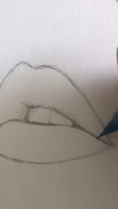 someone is drawing a lips on paper with a pencil