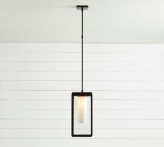 a black and white light hanging from a ceiling