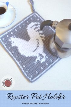 a crocheted mouse pad with a coffee cup and teapot on it next to a computer mouse