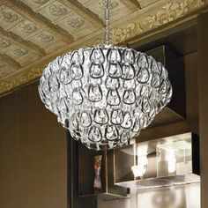 a chandelier hanging from the ceiling in a kitchen