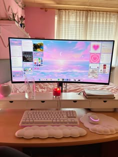 a desk with a computer monitor, keyboard and mouse on it in front of a window