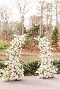 two white and pink flowers are arranged in the shape of letters