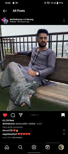 a man sitting on top of a wooden bench