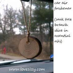 a piece of wood hanging from the side of a car window with an air freshener attached to it