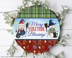 a merry yuletde blessing sign with snowmen and holly wreaths on it