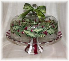 a glass platter with holly and berries on it