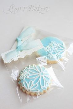 two decorated cookies in plastic bags on a table