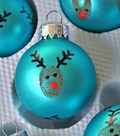 a group of blue ornaments with reindeer faces on them