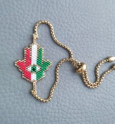 This is an Elegant beaded bracelet featuring Hamsa Palm, it's braided by hand in Italian flag colors and attached to an adjustable stainless steel chain.  This beautiful bracelet makes a beautiful and thoughtful Malocchio protection jewelry and a perfect gift for your loved ones.  Metal parts are made of high quality stainless steel, it's hypoallergenic and durable  All our items are custom made, it takes 3-5 days to get your order prepared.  The delivery date will depend on your location.  * USA - 2 - 4 weeks * Canada - 2 - 5 weeks * Europe - 2-3 weeks * Other - 2 - 4 weeks Please read our frequently asked questions FAQ to find out more Handmade Adjustable Multicolor Chain Bracelet, Adjustable Handmade Multicolor Chain Bracelet, Adjustable Multicolor Handmade Chain Bracelet, Gold Braided Bracelet With Colorful Beads As Gift, Handmade Adjustable Chain Bracelet With Round Beads, Adjustable Multicolor Chain Bracelet, Adjustable Beaded Bohemian Chain Bracelet, Adjustable Bohemian Beaded Chain Bracelet, Adjustable Colorful Beads Rosary Bracelet Gift